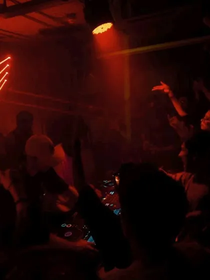 The view from behind the decks at Arcade 140, with lasers and a hyped crowd.