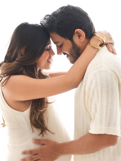 A classic and intimate pose, forehead to forehead, capturing the deep connection and shared love as they await their baby's arrival. A truly timeless maternity portrait.