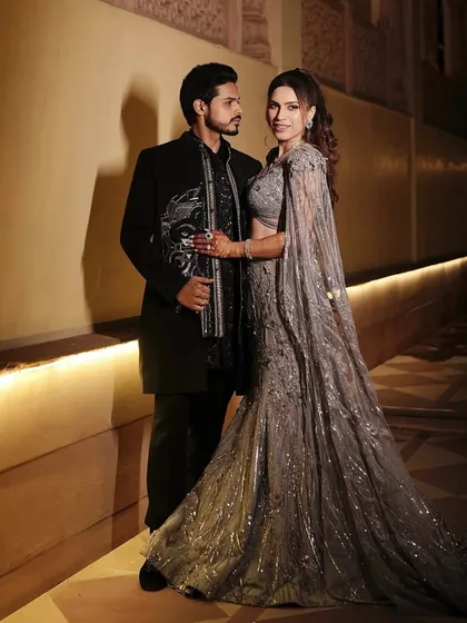 A full-length shot of the couple. Her radiant, refined, and effortlessly glowing makeup look was perfect for her elegant evening event.