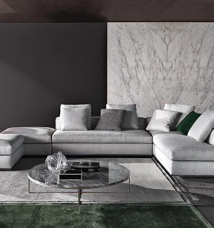 A modern L-shaped sectional in a light grey fabric, perfect for a minimalist and sophisticated interior. I design these pieces to be modular and adaptable to different living room layouts.