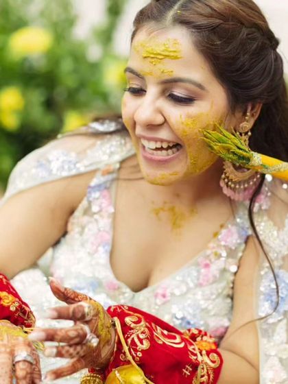 A playful moment during the Haldi. This is why waterproof makeup is a must for this event.