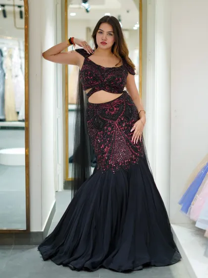 Bring the drama to cocktail night with this black mermaid gown featuring striking red sequin details. The silhouette is designed to hug your curves, while the cut-out detail adds a modern, edgy touch.