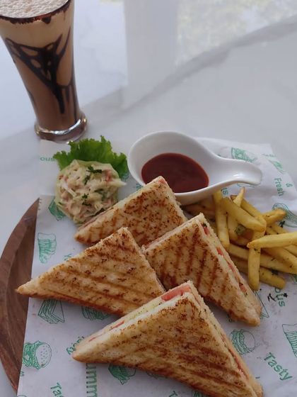 A grilled sandwich platter served with a cold coffee. We can create combo meals for your guests, perfect for conferences or informal gatherings.