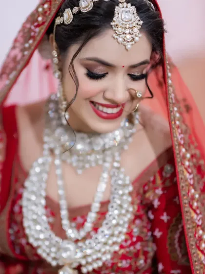 A close-up of the bride's joyful smile, capturing her happiness and the sparkle in her eyes. A perfect candid bridal portrait.