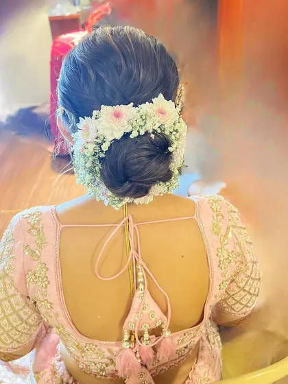 Another angle of the floral bun, showing the beautiful arrangement of flowers and the neatness of the updo.