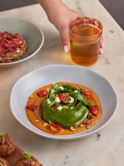 A full spread featuring our popular Spinach and Ricotta Crown Raviolo. It's a dish that's both visually stunning and deeply comforting, perfect alongside our other small plates and a drink.