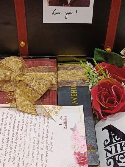 Another view of the 'first salary' gift box, showing the arrangement of the personalized letter, mug, and other items.