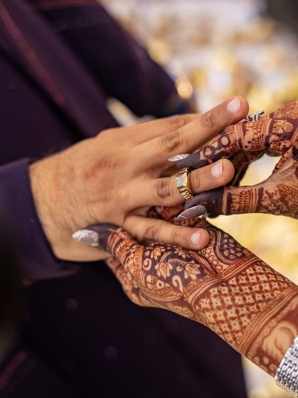 A close-up of the ring ceremony, where you can see the intricate details of the henna design, now a gorgeous deep brown.