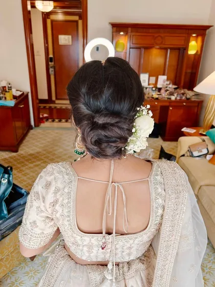 A detailed look at this bride's elegant wedding style, from her flawless makeup to her intricate floral bun.