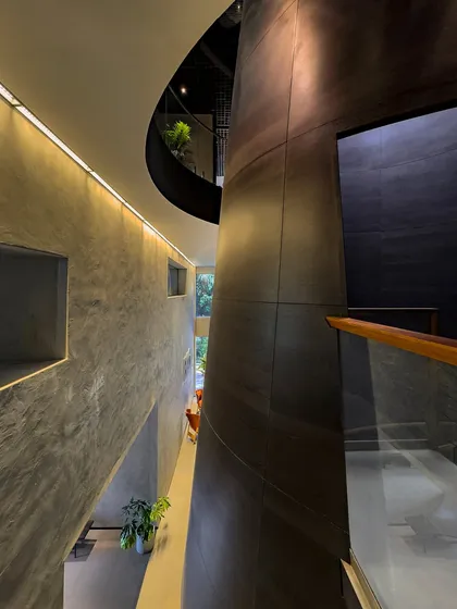 Looking down into the multi-level void at BCG HQ, the interplay of curves and straight lines, light and shadow, creates a complex and visually engaging architectural experience.