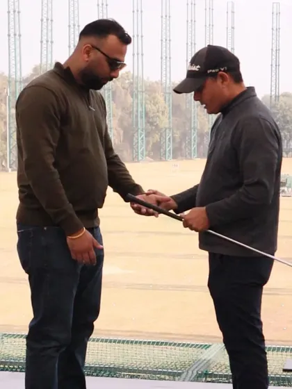 Getting the fundamentals right is key. Here, one of our certified coaches is providing hands-on instruction, helping a player perfect their grip, which is the foundation of a great golf swing.