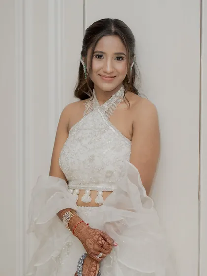 A closer look at Kaaya's fresh and modern makeup. The halter neck top and soft hair create a very chic look for a bridesmaid or sister.