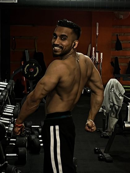A strong back is essential for overall fitness and a balanced physique. This pose showcases the muscle definition achieved through consistent training.