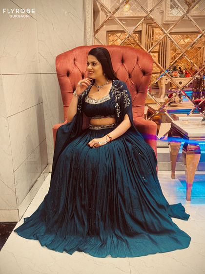 Another angle of this regal blue lehenga, showing how the light catches the pleats and embroidery. A perfect outfit for a wedding guest.