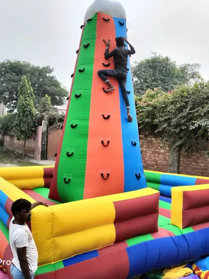 Here is our 16x16 feet standalone inflatable climbing wall in action. It's a four-sided tower, allowing multiple people to climb at once, making it a fantastic and challenging attraction for any event.