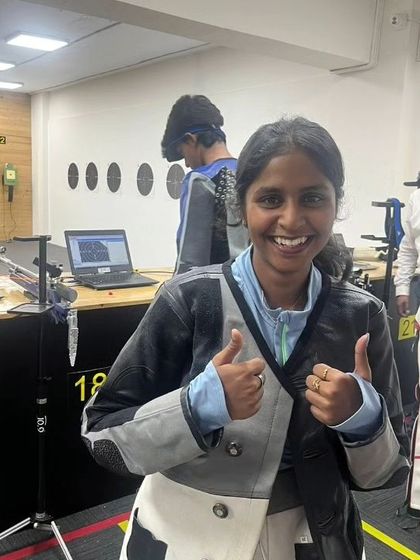 The joy of a good performance. A shooter gives a thumbs-up after her session, with our electronic targets displaying results in the background.