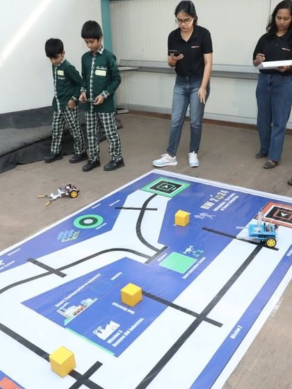 Students test their line-follower robot on a custom-designed track. This exercise teaches them about sensors, motor control, and programming logic in a fun and competitive way.