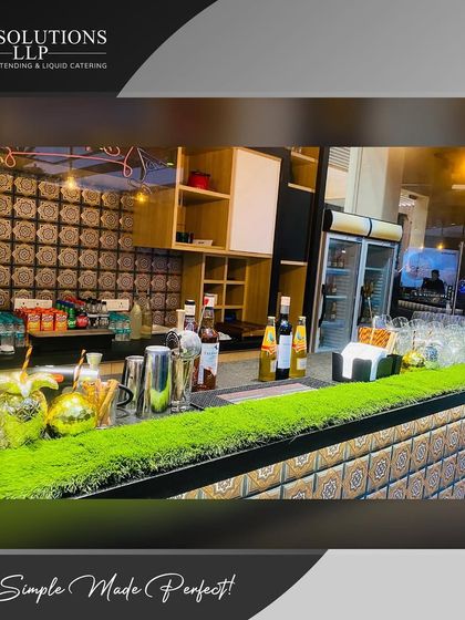 A side view of our mobile bar setup for a private house party, complete with turf accents and elegant lighting.