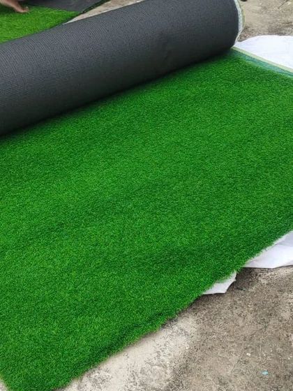 A roll of our high-quality artificial turf, ready for installation. The dense fibers and rich green color provide a realistic look and feel.