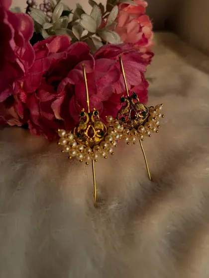 A still shot of the red and green stone ear cuffs.