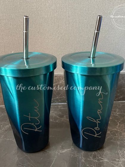 This personalized chrome tumbler with a matching steel straw has a stunning iridescent finish. It's a stylish and modern drinkware option that can be customized with a name.