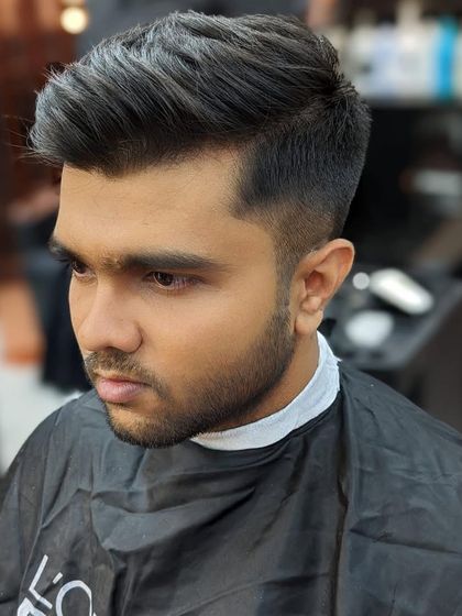 Another angle of a fresh, modern haircut. This shows how the style looks from the front, highlighting the clean side part and expertly managed volume.
