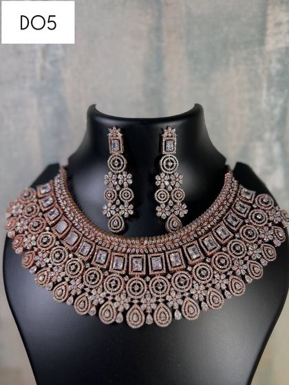 This rose gold American diamond choker has a very detailed, traditional pattern. It's a great rental for pairing with an ethnic outfit for a wedding function or festive celebration.