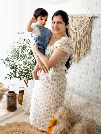 A mother holds her sweet baby boy. The coordinating denim and white outfits look fantastic in my bright and airy boho studio.