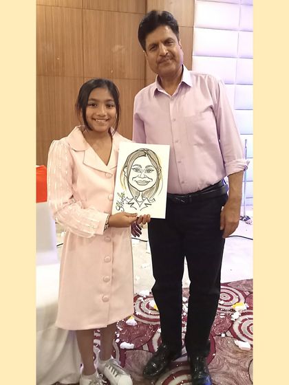 Standing with a happy client and her caricature. It’s a great photo opportunity for guests and a memory they can share.