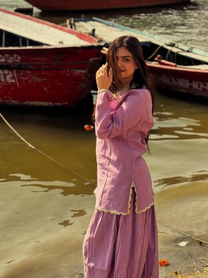 A candid moment by the ghats of Banaras, wearing a simple yet elegant ethnic outfit that complements the spiritual vibe of the city.