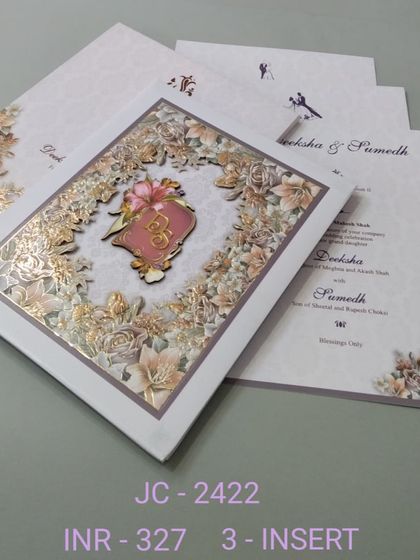This invitation features a beautiful laser-cut floral frame around a custom monogram emblem. The design is intricate and delicate, offering a luxurious feel for your wedding stationery.