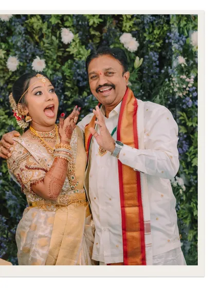 A fun and candid moment between the bride and her father, their playful expressions showing a lifetime of love and laughter.