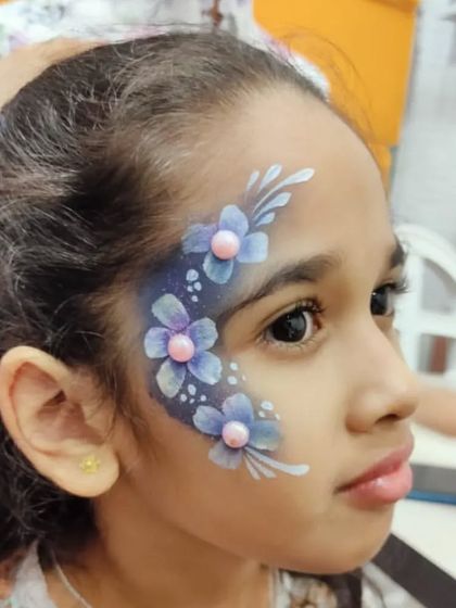 A beautiful floral design with blue and purple flowers, adorned with pearl-like gems for a 3D effect.