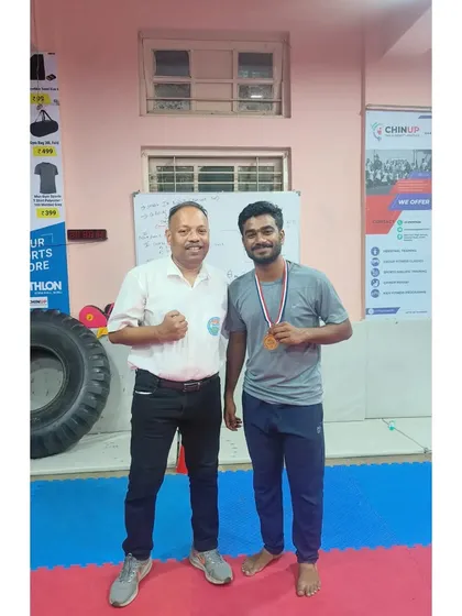 Our coach stands proudly with an athlete who won multiple gold medals at the Mumbai City Championship, a testament to our effective mentorship.