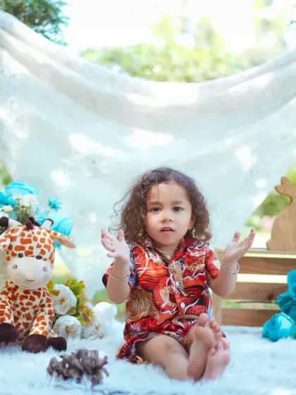 An expressive moment captured during an outdoor shoot. The natural backdrop and soft lighting create a beautiful, dreamy portrait.