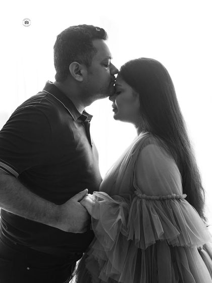 A black and white silhouette of a partner kissing his wife's forehead. This is a simple, powerful image of love and support.