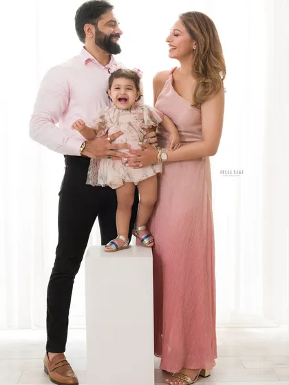 A portrait of a family's pure joy. This is what it's all about: unscripted laughter and the kind of love that fills a room, captured in a bright, classic family photograph you'll cherish forever.