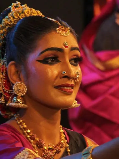 A close-up of a dancer's expressive face during the 'Ayyappa Kavuthuvam' performance, capturing the devotion and emotion conveyed through abhinaya.