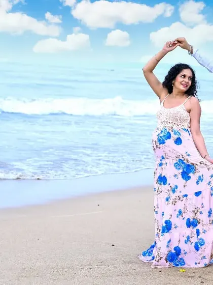 A dance by the waves. This joyful, spontaneous moment captures the happiness and excitement of the parents-to-be.