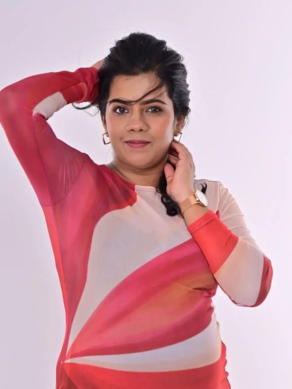 A confident and stylish pose. The makeup is minimal, focusing on flawless skin and defined eyes, letting the modern dress and her personality take center stage.