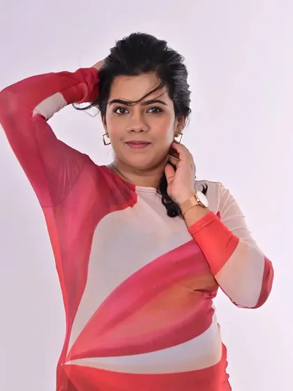 A confident and stylish pose. The makeup is minimal, focusing on flawless skin and defined eyes, letting the modern dress and her personality take center stage.
