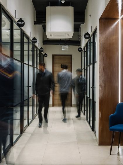 Motion blur captures the energy of the office corridor, a central artery connecting the various workspaces.