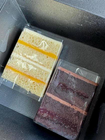 Two of our delicious cake slices, Lemon Coconut and a rich chocolate flavour, packaged together.