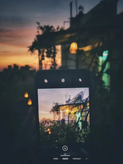 Capturing the magic within the magic. This is a photo of my phone capturing the garden at sunset, a reminder to always find and appreciate the beauty in every moment.