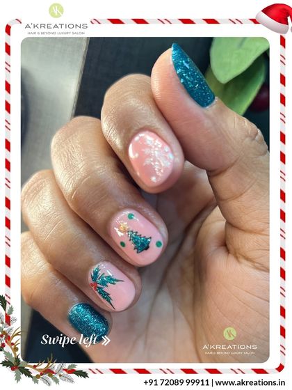 A closer view of the playful Christmas nail art, highlighting the glittery teal polish and the detailed illustrations on the pink nails.