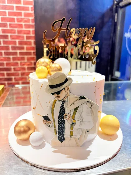 A stylish cake with a dapper man illustration, perfect for a fashionable guy's birthday.