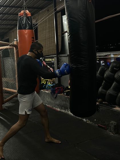 A fighter drilling his boxing form on the heavy bag. This is where you build power and endurance, one punch at a time.
