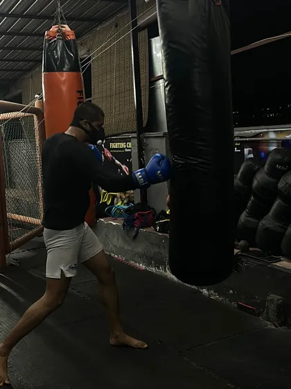 A close-up of a punch connecting with the heavy bag, showcasing the moment of impact and the correct form for a straight punch.
