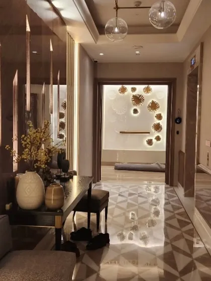 A view of a hallway in the Sekhri residence, featuring a geometric marble floor and a beautifully lit art niche. This space demonstrates my focus on creating visual interest in transitional areas.