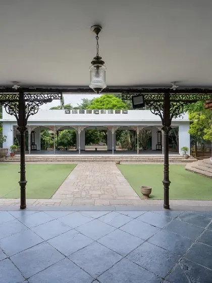 A view of the grand lawn and our colonial bandstand, framed by antique pillars. This open space is perfect for large ceremonies, offering a sense of scale and history.